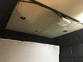 Netting attached to the top of screen and sloped up toward the ceiling.