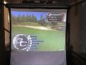 Here is a picture of it.  Lights are out but it looks good with the lights on.  My Homecourse screen is small, only 8x8' i believe but this projector works prefectly with it based on my distance.  Mounted about 13' high behind me as my garage has a lot of height.