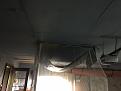 Here is my setup.  The left of the hanging down tarp is the screen.   It sags low enough to catch lob wedge shots from about 10 feet away,   Also, protects the ceiling, blocks the top of the screen frame and limits bounce back.  Cheap vinyl tarp in a pleasing dark blue...