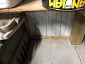 Pole barn support with corrugated steel behind it