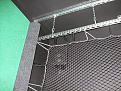 Net that backs up the impact screen. Note that screen height is less than the height of the room, hence the chains holding the actual channel that will support the impact screen.