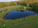 Golf green from sim area. Garage Door opens and can hit 140 yards out to green over pond.
