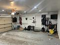 Junk in garage ready to be moved and designated golf area under tv