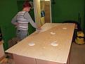 Glue being spread on wall panel for attachment of PEF