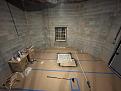 Lower level total 15 x 15ft space, 12ft high ceiling.  Front walls are angled in the corners